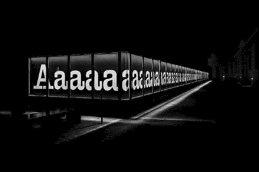 the letters 'Aaaaaaaaaaaa[…]' are painted in red on a black background. it's night and these letters are displayed inside lit vitrines (glass display cases) positioned on the facade of a brick building along a narrow alleyway.